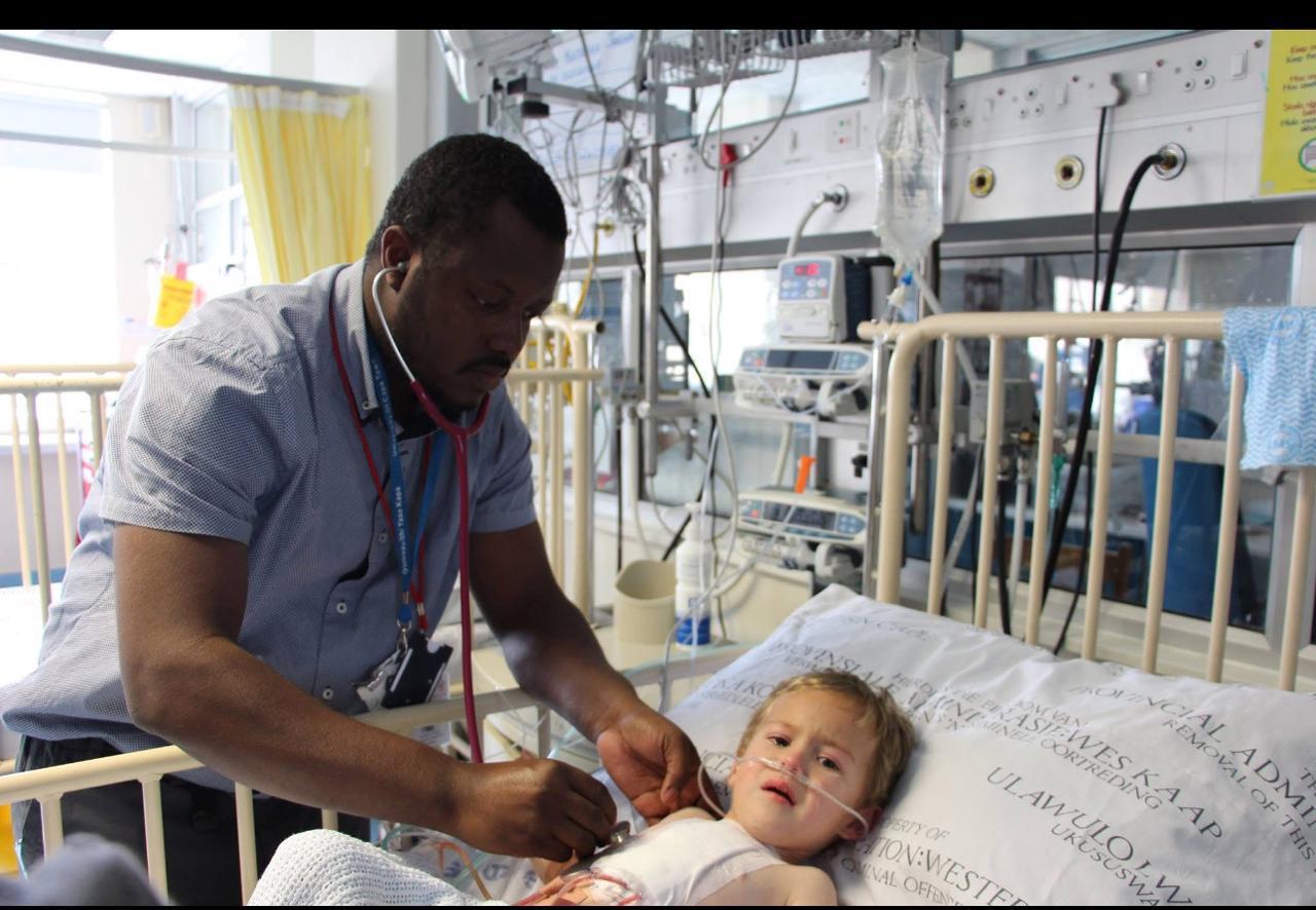 Dr A A Jalloh assessing a child in a hospital setting